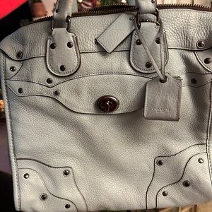 Larger size coach purse. It’s light blue and large enough to fit a laptop.